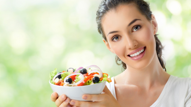 Woman smiling holding salad green free wallpaper for desktop - medium preview image