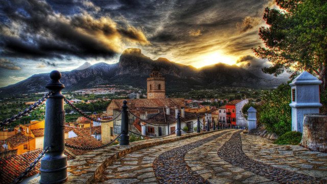 Cobblestone village clocktower mountain landscape free wallpaper for desktop - medium preview image
