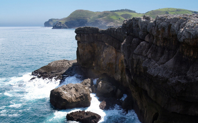 Rocky cliff water grassy hill #2 free wallpaper for desktop - medium preview image