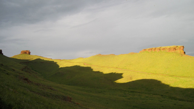 Grassy hill cloudy sky landscape free wallpaper for desktop - medium preview image