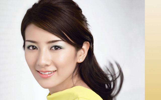 Woman ponytail yellow shirt smiling free wallpaper for desktop - medium preview image