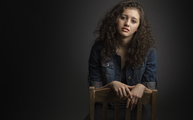 Woman sitting crossed arms serious free wallpaper for desktop - medium preview image