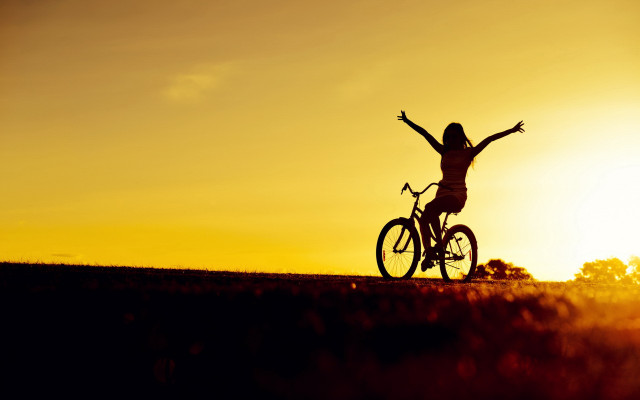 Sunset biker arms outstretched hill free wallpaper for desktop - medium preview image