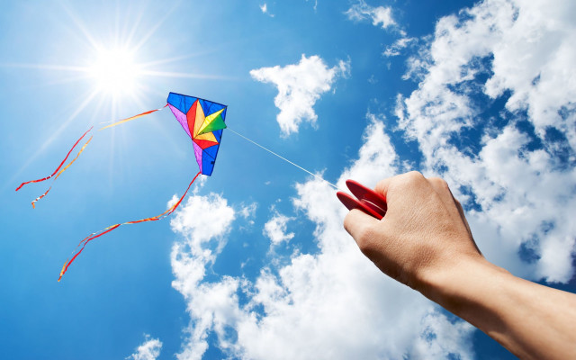 Kite flying sun clouds ocean free wallpaper for desktop - medium preview image