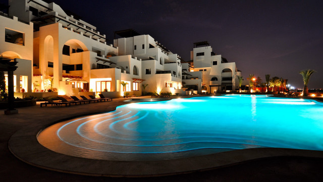 Lit up pool cityscape night free wallpaper for desktop - medium preview image