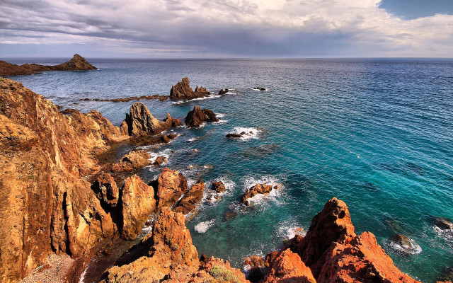 Rocky coast mountainous horizon ocean free wallpaper for desktop - medium preview image