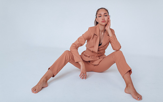 Woman tan suit sitting portrait free wallpaper for desktop - medium preview image