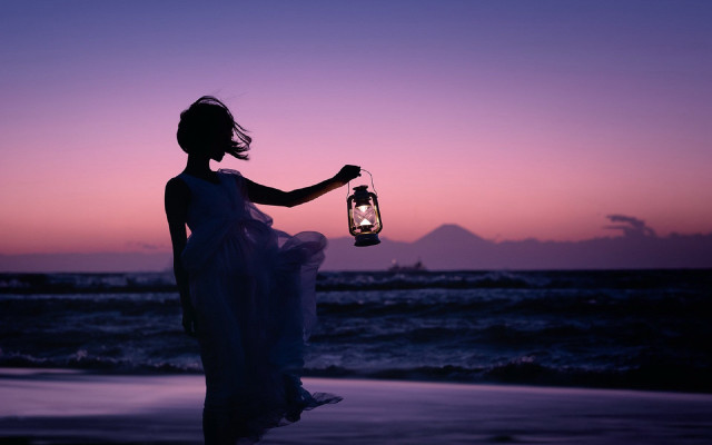 Woman lantern beach sunset mountain free wallpaper for desktop - medium preview image