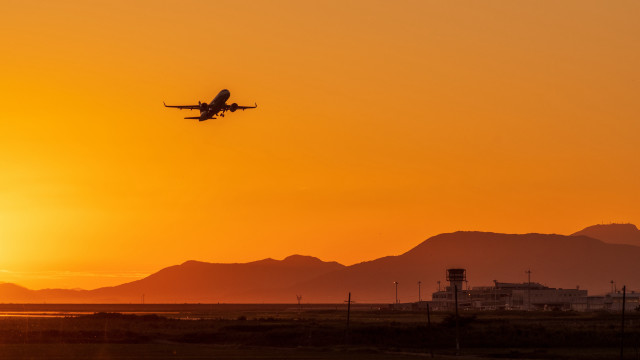 Sunset plane mountains building city free wallpaper for desktop - medium preview image
