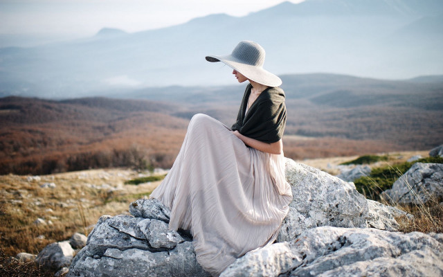 Woman sitting rock hat lake free wallpaper for desktop - medium preview image