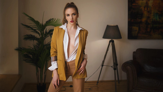 Woman yellow jacket tan pants free wallpaper for desktop - medium preview image