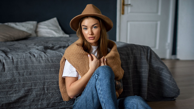 Woman sitting hat sweater portrait free wallpaper for desktop - medium preview image