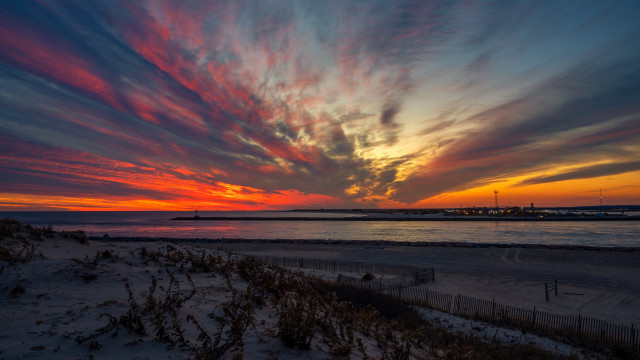 Sunset beach fence lighthouse cityscape free wallpaper for desktop - medium preview image