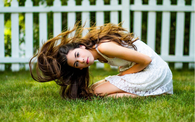 Woman kneeling grass wind whitefence free wallpaper for desktop - medium preview image