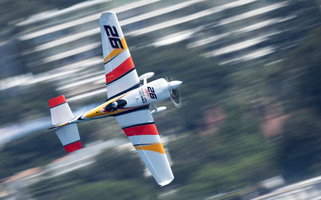 Small airplane flying trees blurry free wallpaper for desktop - medium preview image