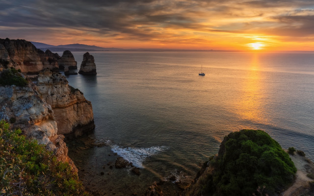 Boat sunset rockycliff lake cloudscape free wallpaper for desktop - medium preview image