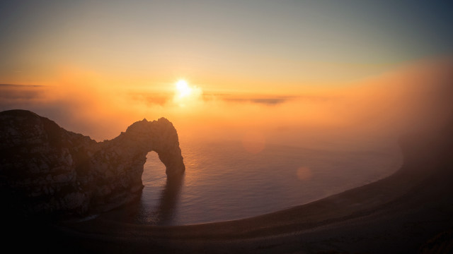 Sunset foggy mountain arch volumetric free wallpaper for desktop - medium preview image