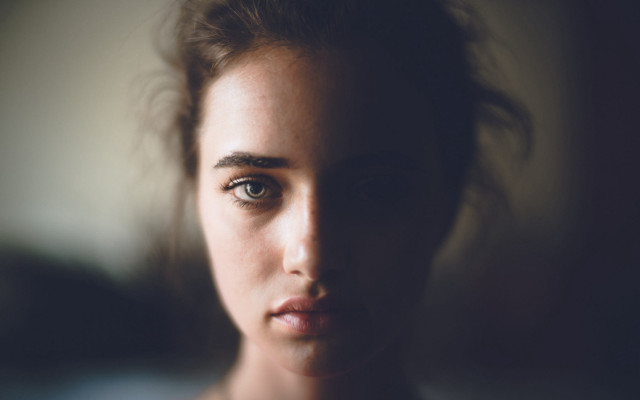 Serious woman blurry background portrait free wallpaper for desktop - medium preview image