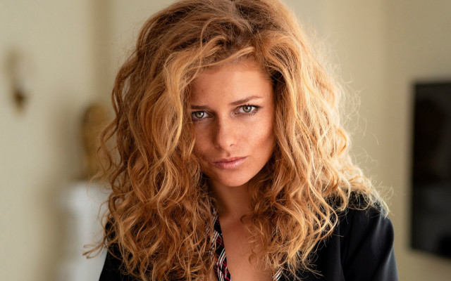 Serious blonde curly wavy portrait free wallpaper for desktop - medium preview image