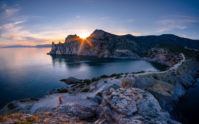 Cliff overlooking water mountains sunset free wallpaper for desktop - medium preview image
