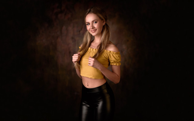 Woman yellow top black background free wallpaper for desktop - medium preview image