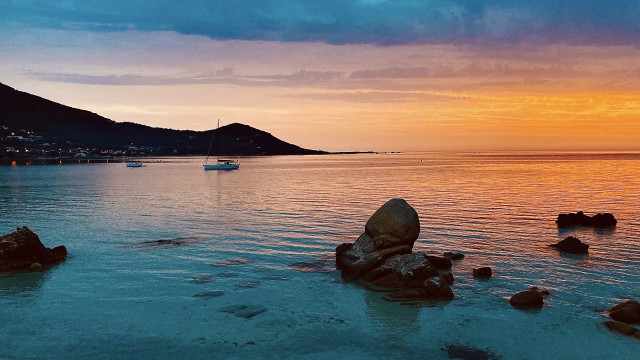 Boat rocky shore sunset mountain free wallpaper for desktop - medium preview image