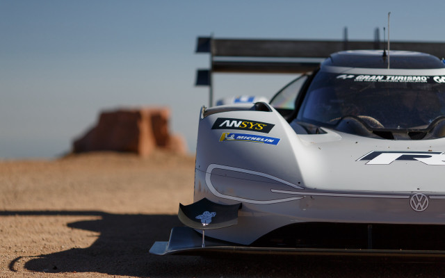 Silver racecar dirtroad rocks sky free wallpaper for desktop - medium preview image