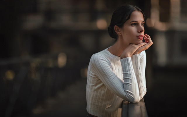 Woman leaning railing serious bokeh free wallpaper for desktop - medium preview image