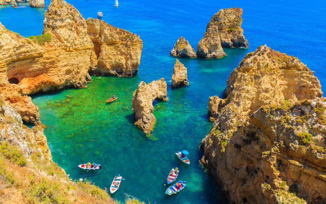 Boats rocks cliffs ocean beach free wallpaper for desktop - medium preview image