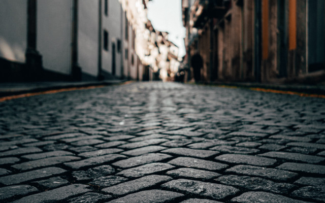 Cobblestone street stop sign tiltshift free wallpaper for desktop - medium preview image
