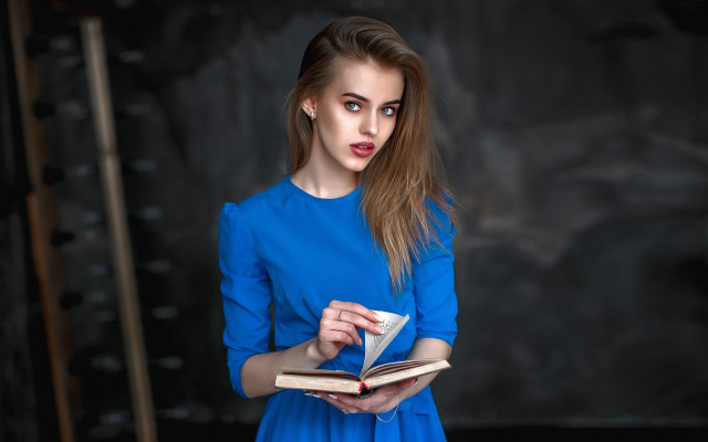 Surprised woman blue dress reading free wallpaper for desktop - medium preview image