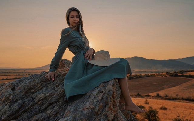 Woman sitting rock hat sunset free wallpaper for desktop - medium preview image