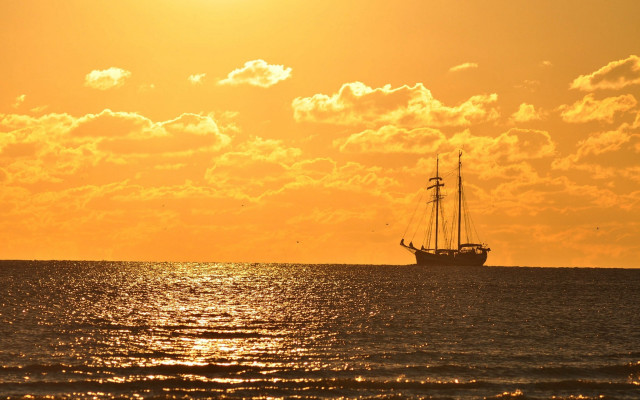 Sailboat ocean sunset clouds yellow free wallpaper for desktop - medium preview image