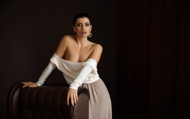 Woman white top brown chair free wallpaper for desktop - medium preview image