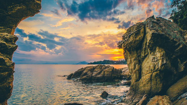 Sunset cave ocean rocky shore free wallpaper for desktop - medium preview image