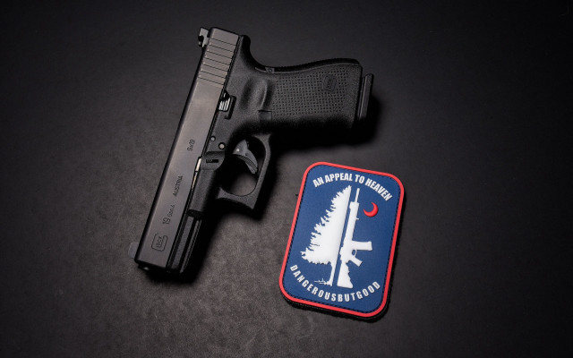 Gun patch black surface red free wallpaper for desktop - medium preview image