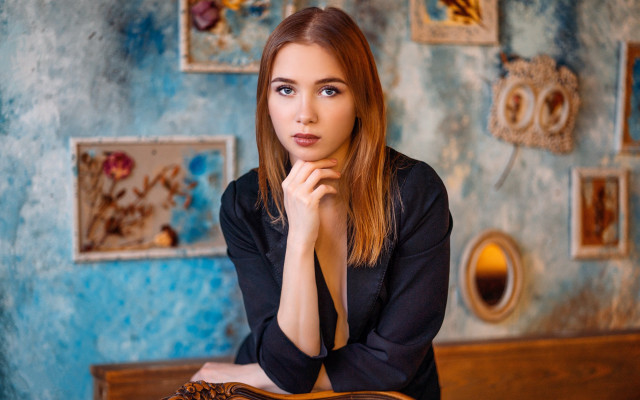 Woman sitting blue wall portrait free wallpaper for desktop - medium preview image