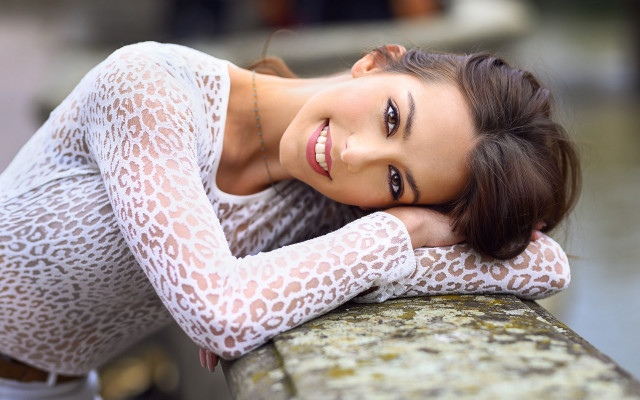 Woman smiling leaning wall brown free wallpaper for desktop - medium preview image