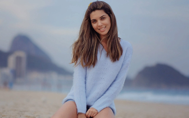 Woman beach blue sweater sitting free wallpaper for desktop - medium preview image