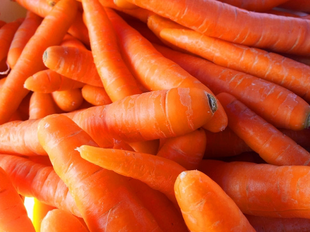 Pile of carrots next to free wallpaper for desktop - medium preview image