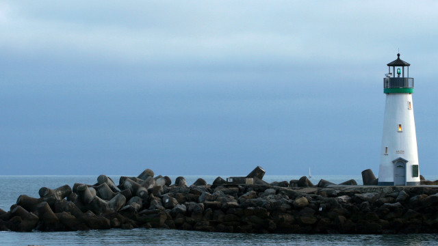 Lighthouse rocky pier water cloudy free wallpaper for desktop - medium preview image