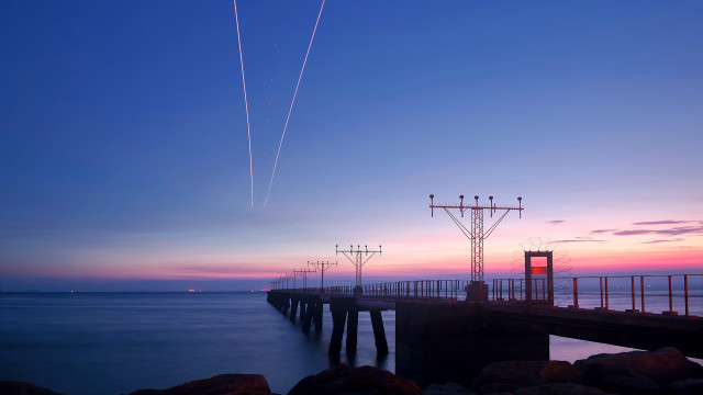 Pier plane sunset contrails water free wallpaper for desktop - medium preview image