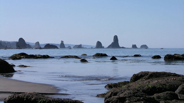 Beach rocks water hill sky free wallpaper for desktop - medium preview image