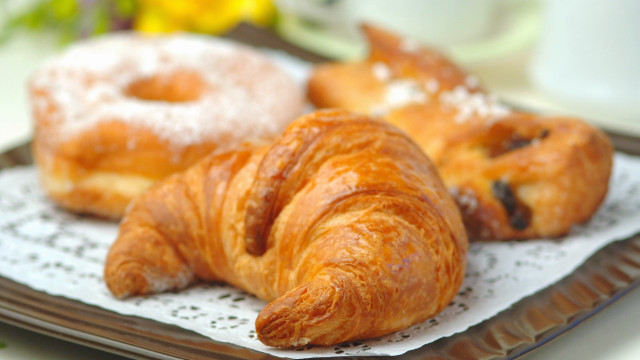 Croissants on plate next to free wallpaper for desktop - medium preview image