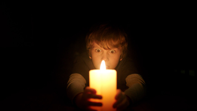 Creepy person holding candle dark free wallpaper for desktop - medium preview image