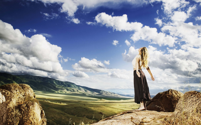 Woman rock formation sky clouds free wallpaper for desktop - medium preview image