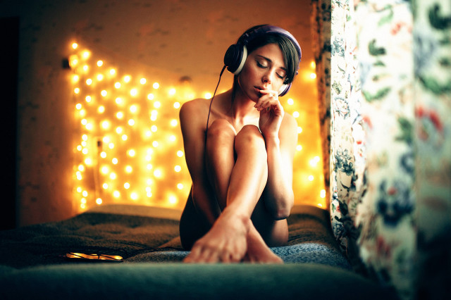 Woman sitting headphones blur bokeh free wallpaper for desktop - medium preview image