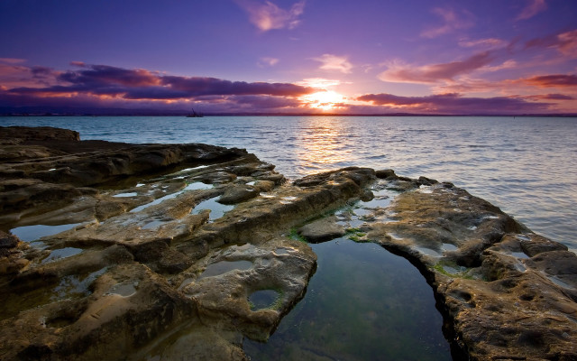 Sunset water rocks boat distant free wallpaper for desktop - medium preview image