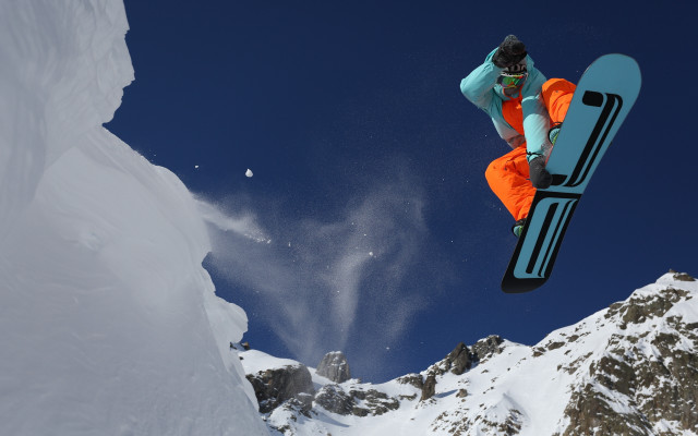 Snowboarder orange pants trick mountain free wallpaper for desktop - medium preview image