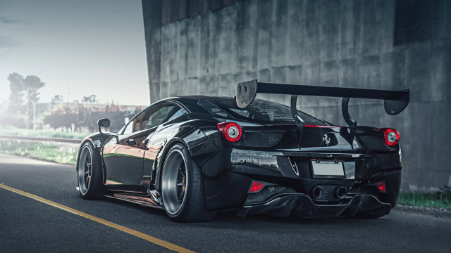Black sports car driving building free wallpaper for desktop - medium preview image